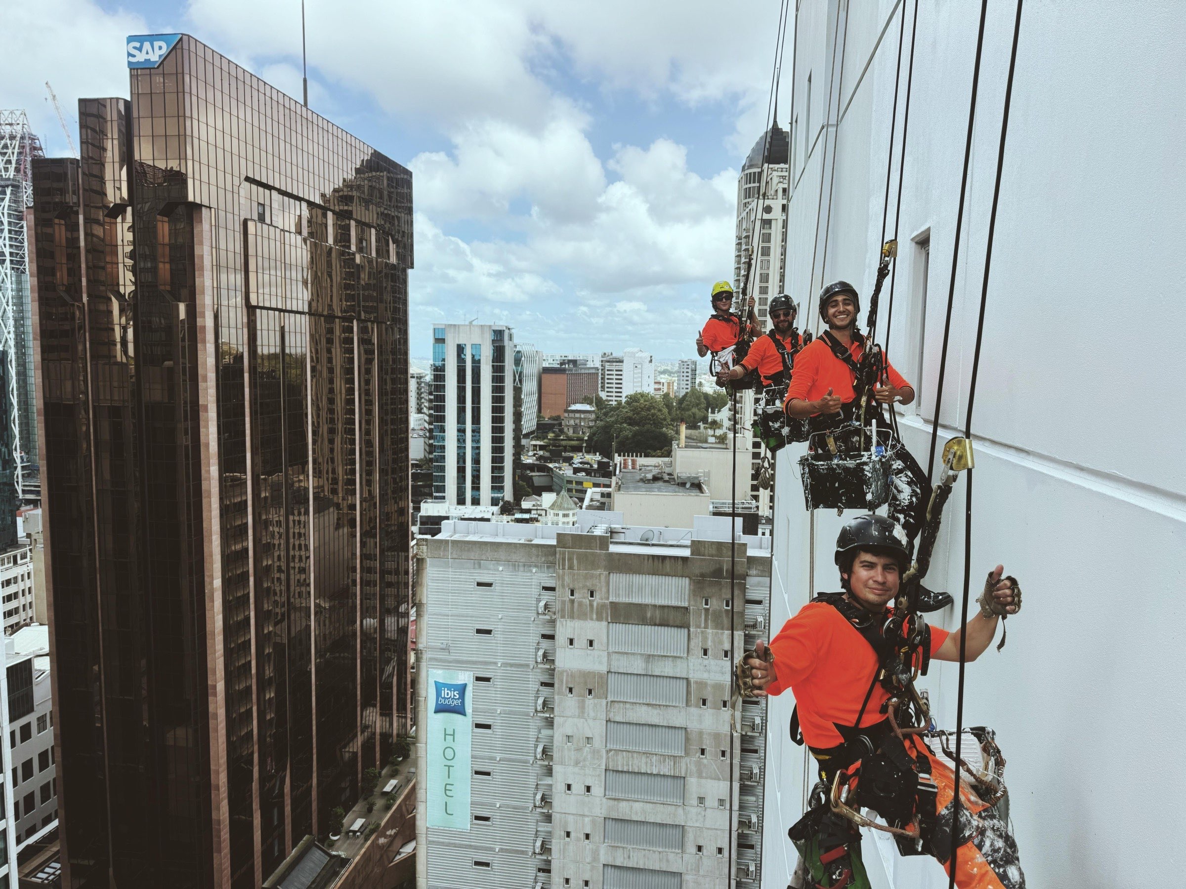 Four On Ropes technicians working one Auckland CBD elevation from twin ropes
